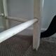 Vintage wooden stool with white peeling paint
