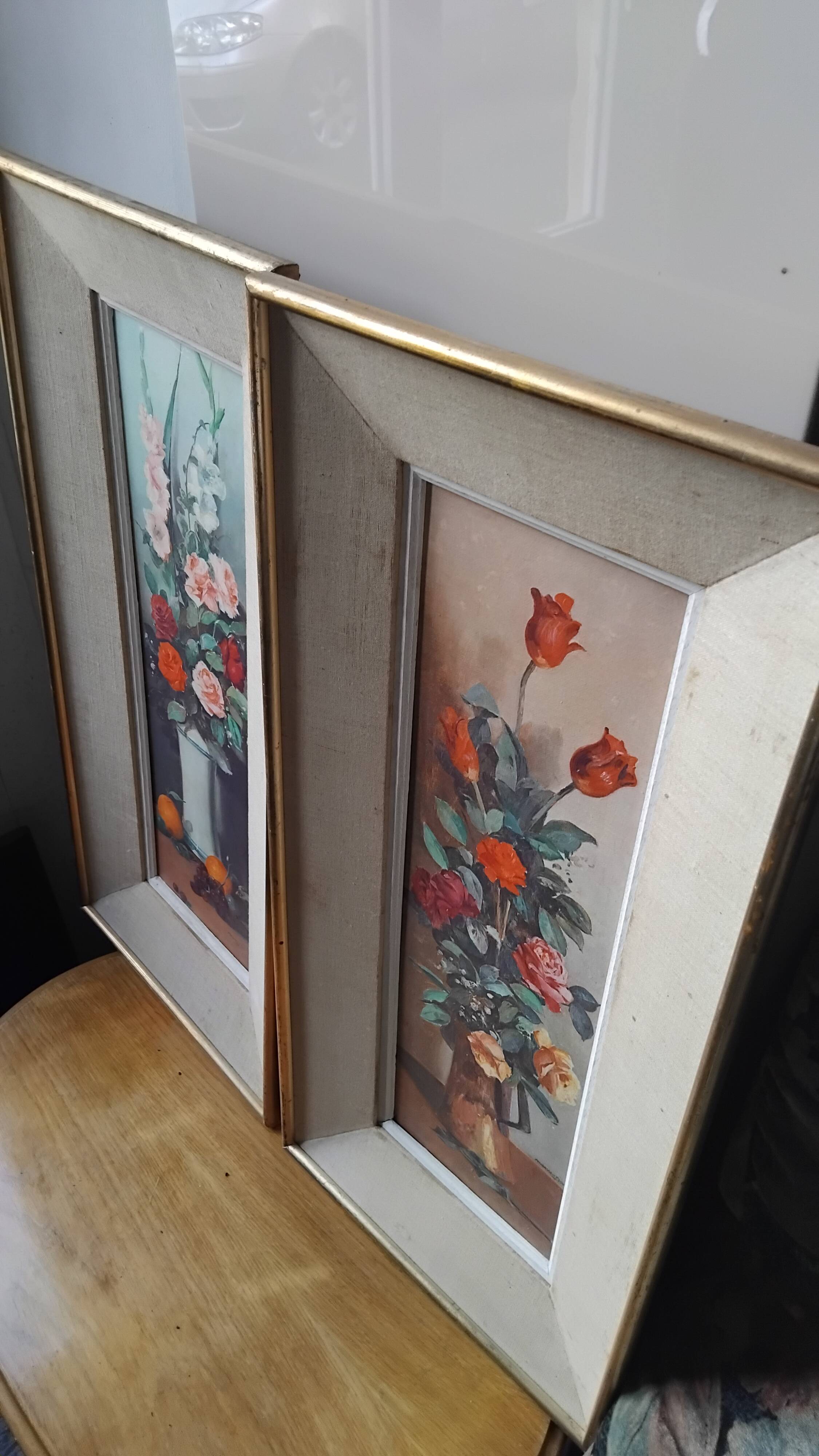 Pair of framed paintings featuring a composition of flowers.