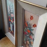 Pair of framed paintings featuring a composition of flowers.