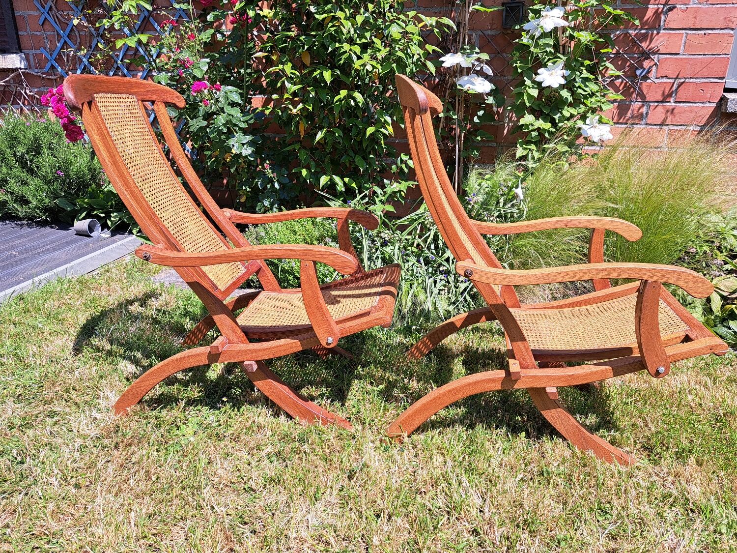 Pair of teak and cane deckchairs