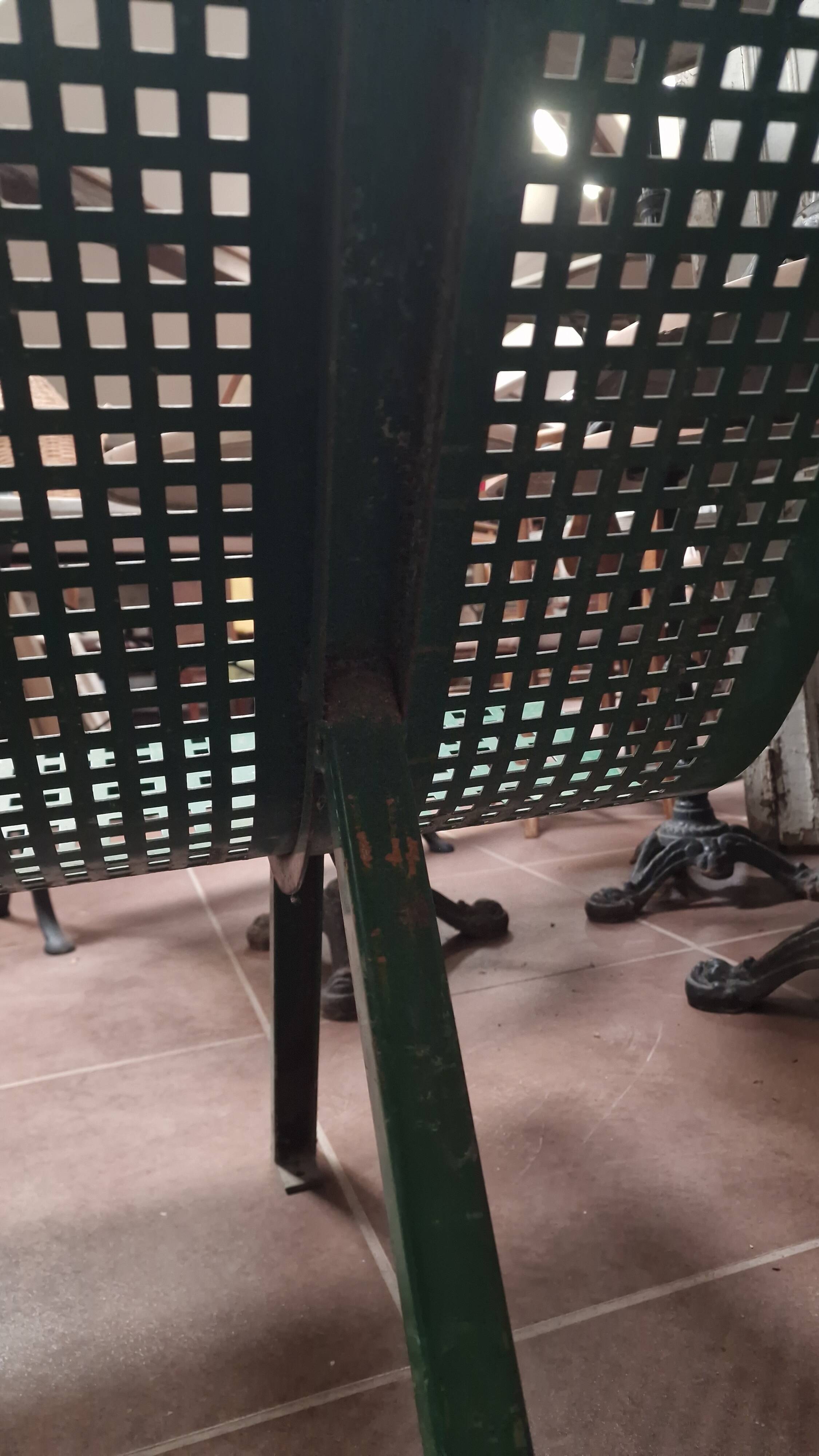 Vintage green perforated metal public bench