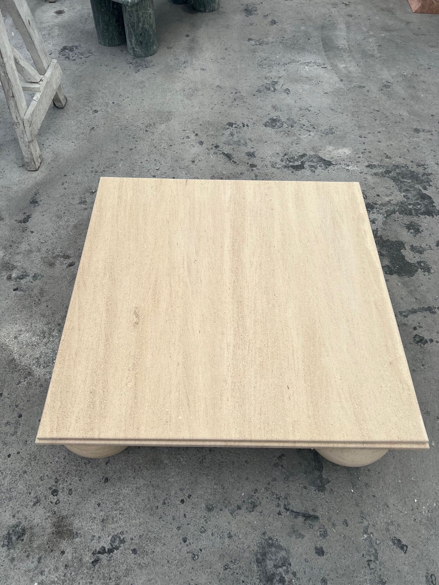 Square stone coffee table with sculptural ball legs