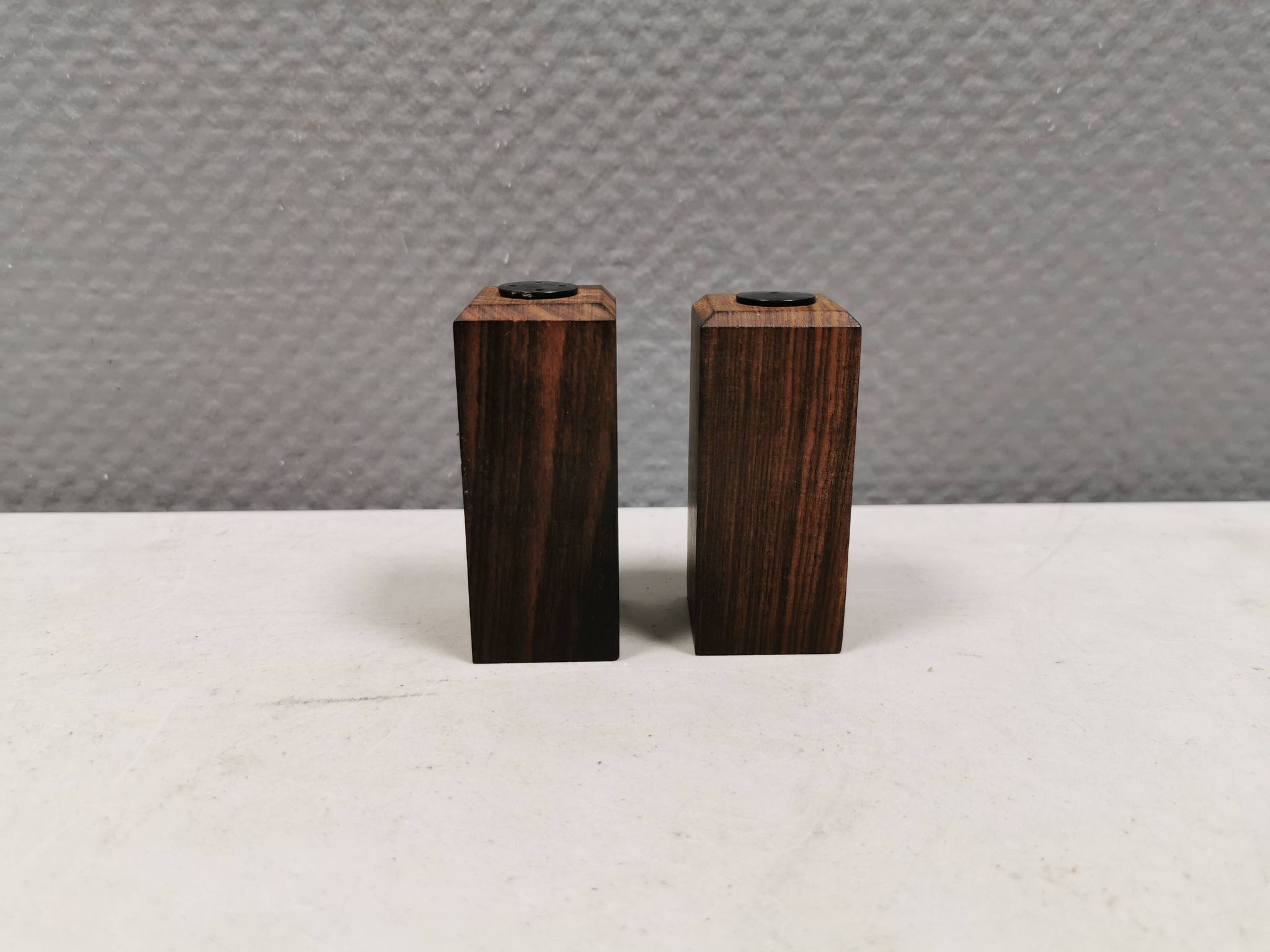 A set of salt and pepper shakers in rosewood