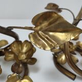 Pair of brass candle holders decorated with patinated metal flowers