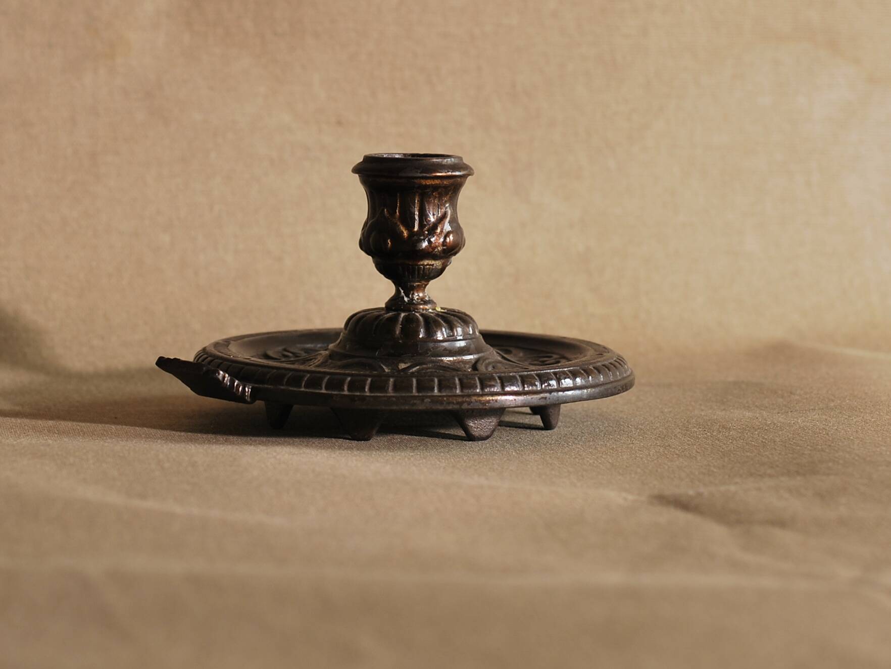 Bronze cellar rat hand candle holder