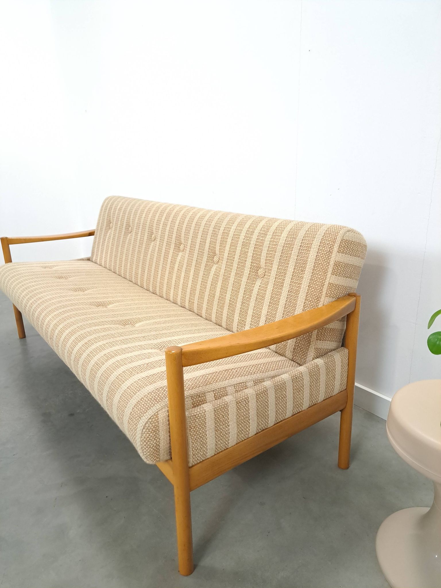 Canapé-lit beige rayé avec cadre en bois