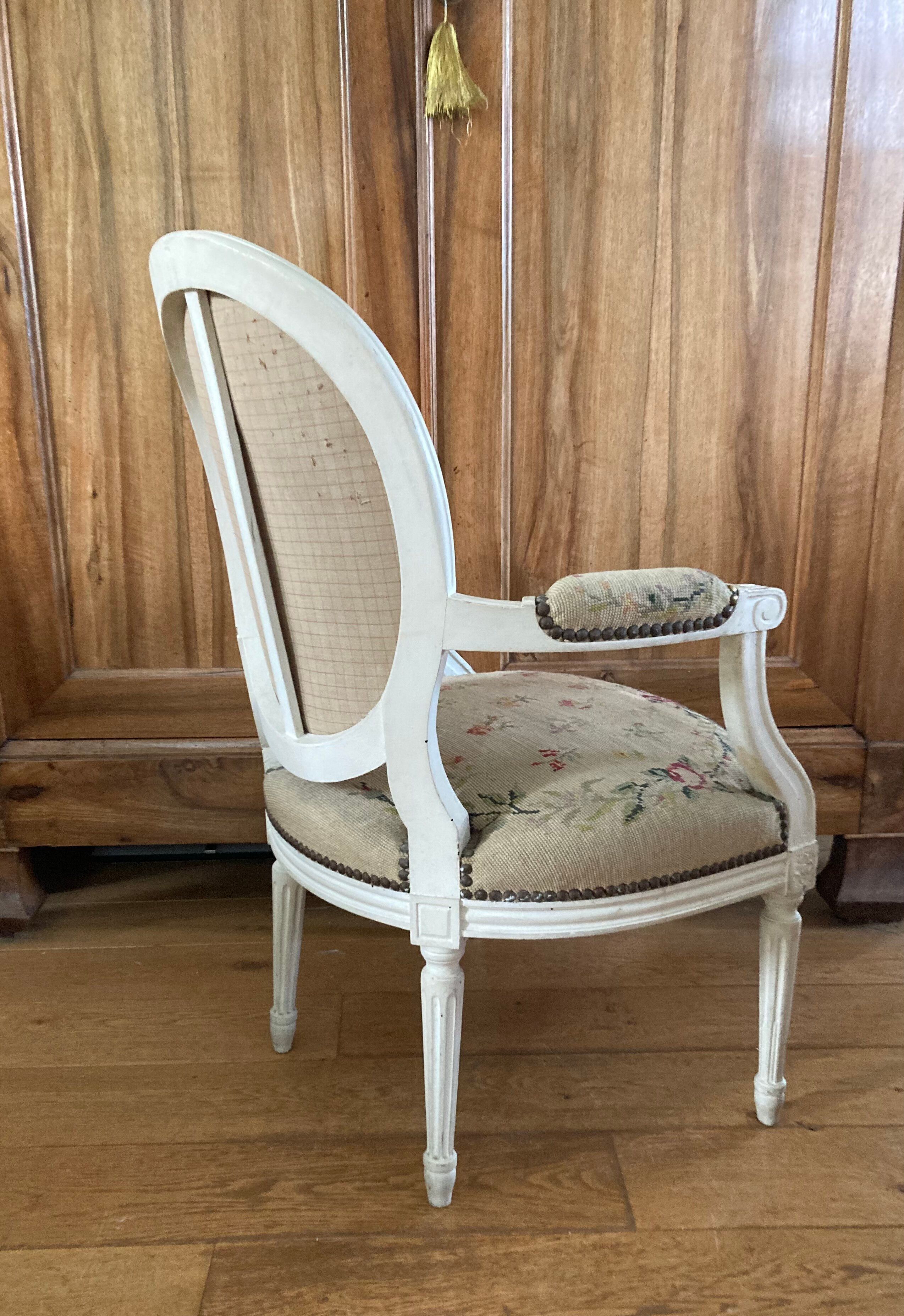 Upholstered armchair with cross-stitch in the Louis XVI style, 19th century.