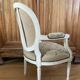 Upholstered armchair with cross-stitch in the Louis XVI style, 19th century.