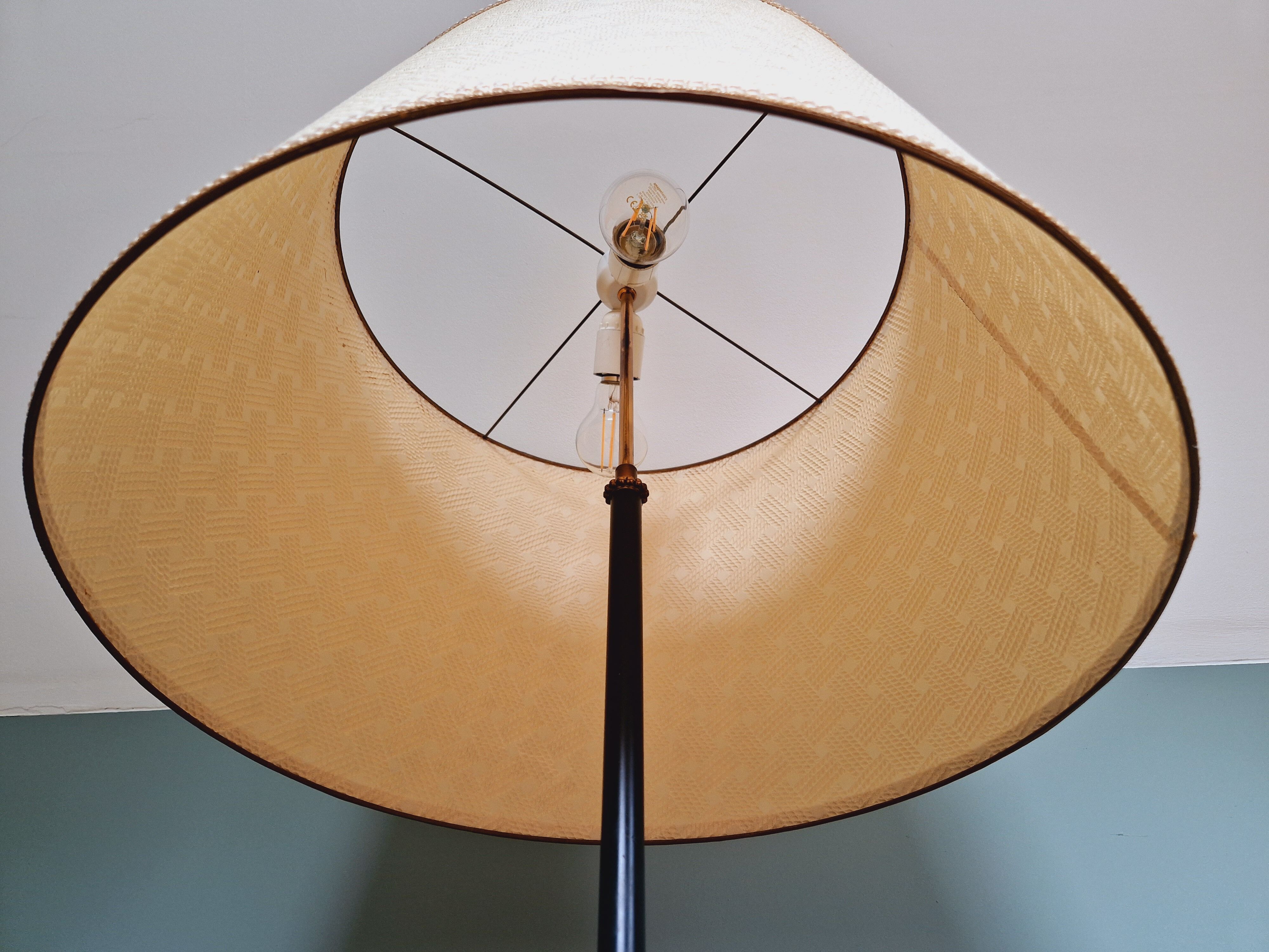 Vintage tripod floor lamp in black lacquered metal and brass, 50s