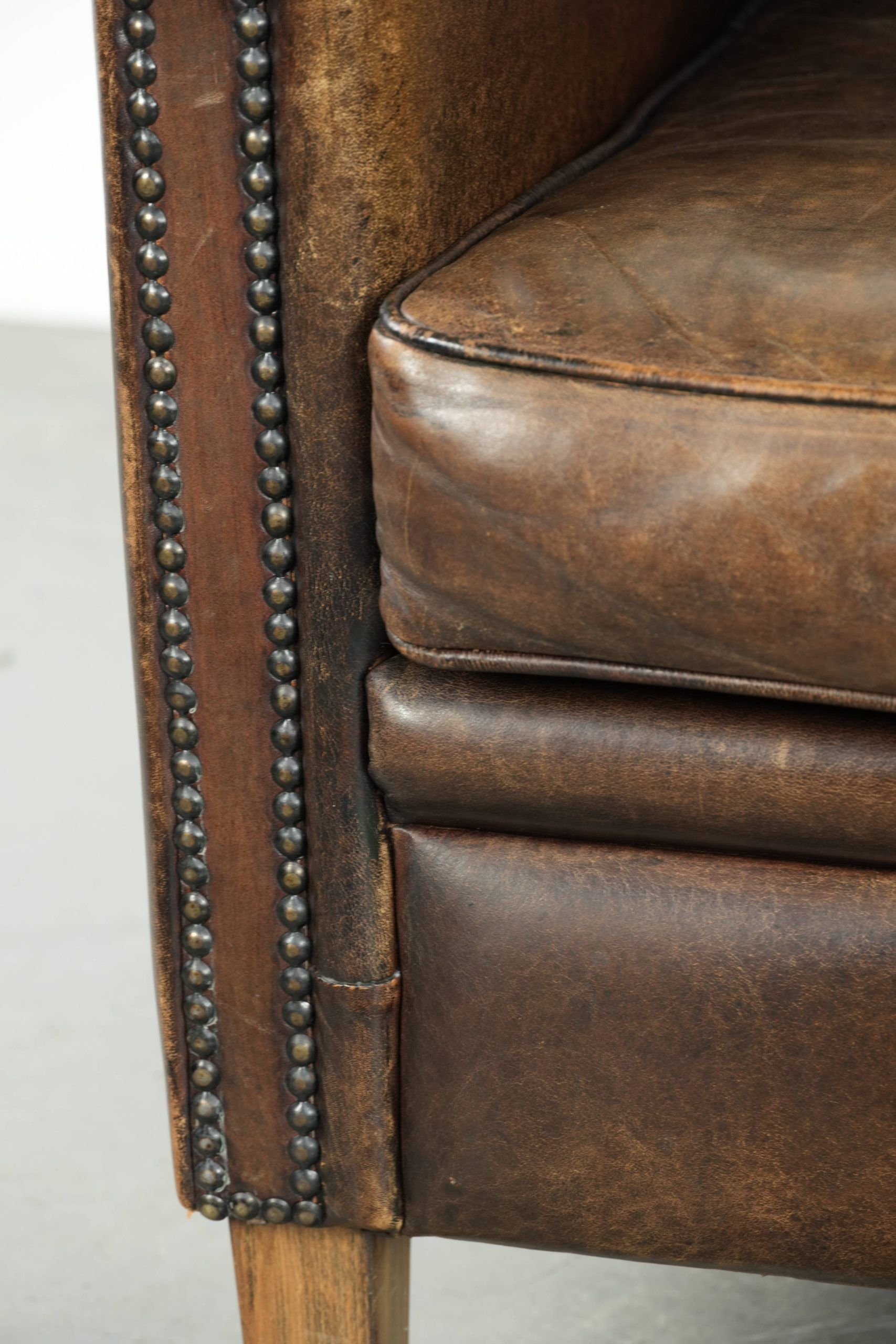 Armchair / lounge chair made of sheepskin leather with characterful patina