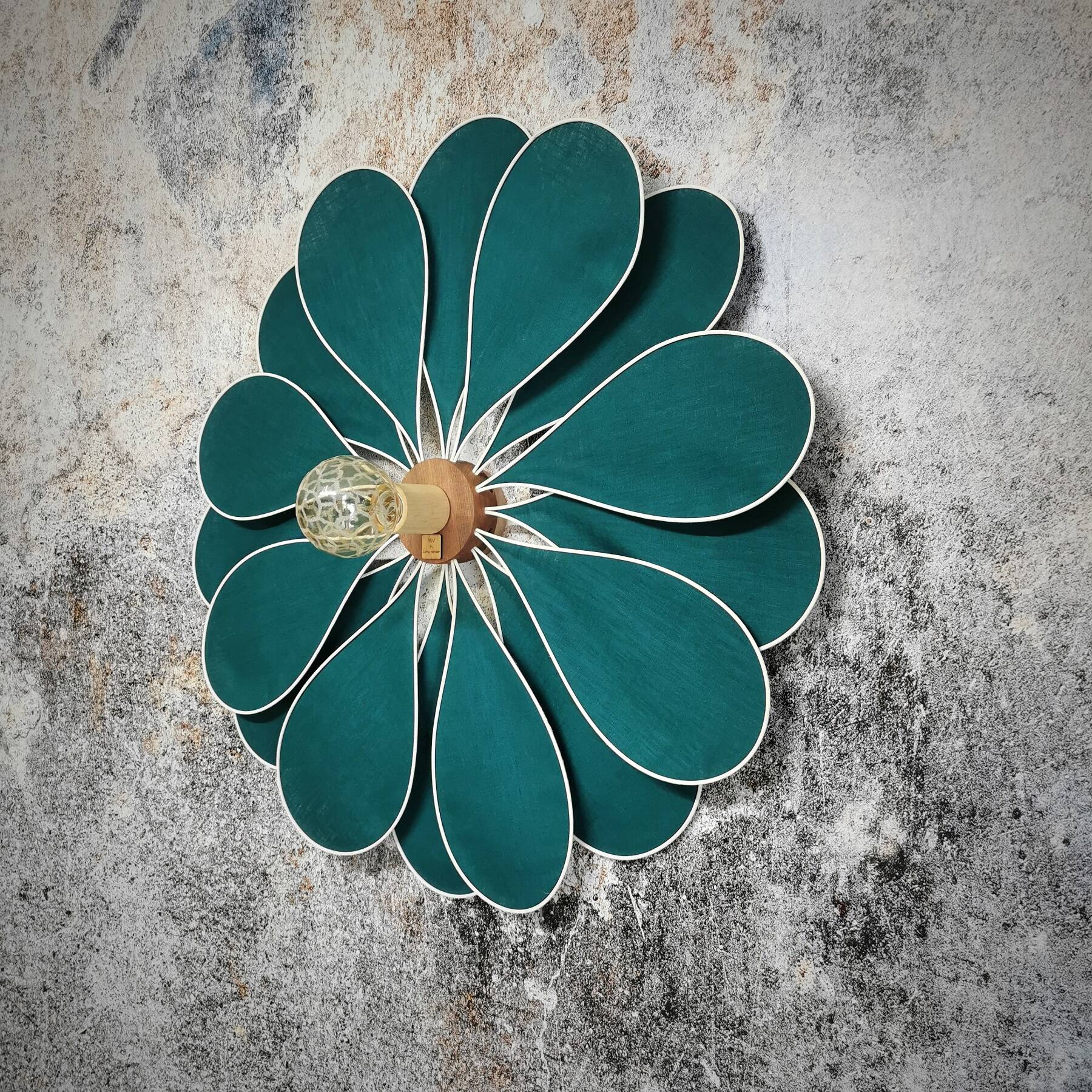 Emerald green rattan and linen flower wall light with 16 petals