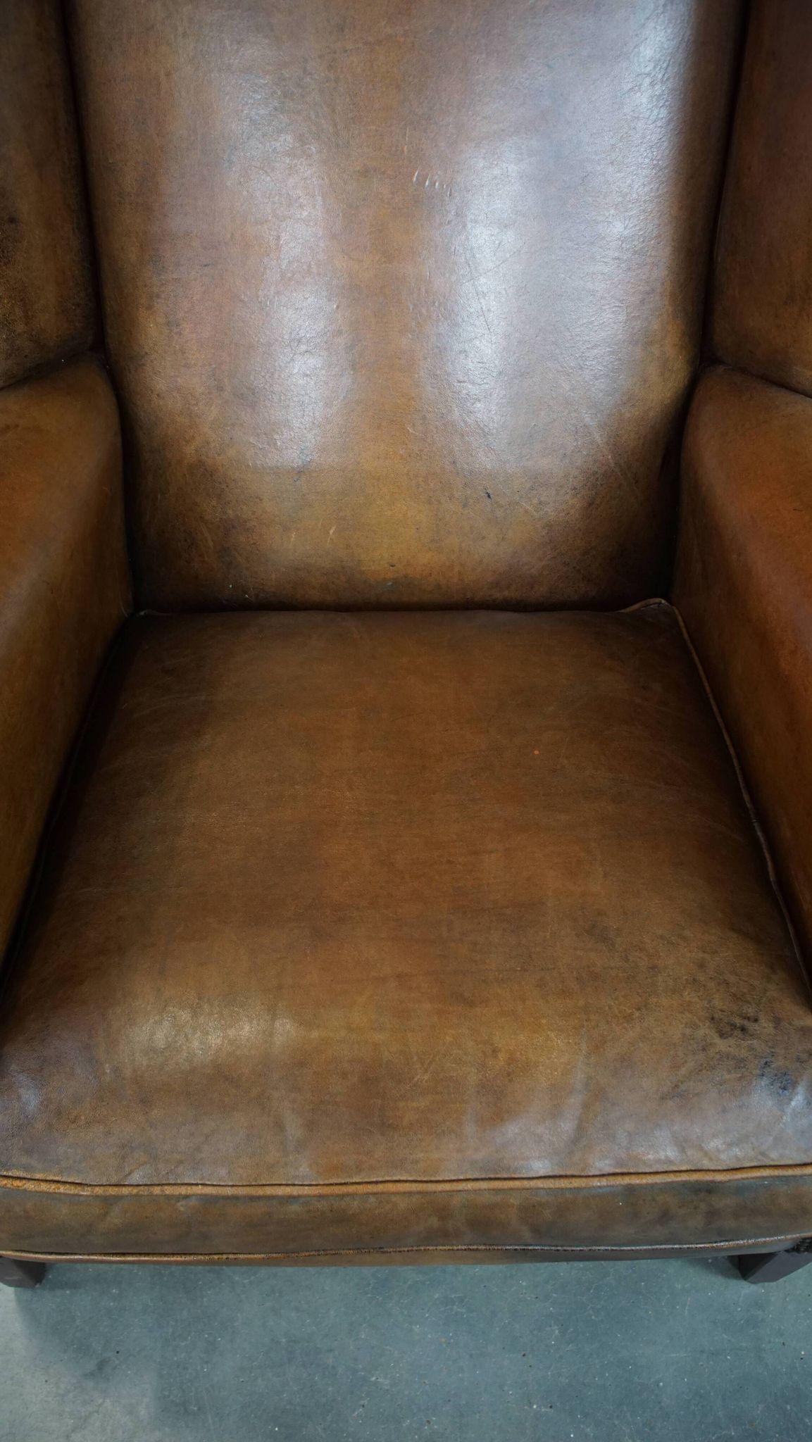 Sheepskin wing chair + XXL patinated footrest