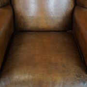 Sheepskin wing chair + XXL patinated footrest