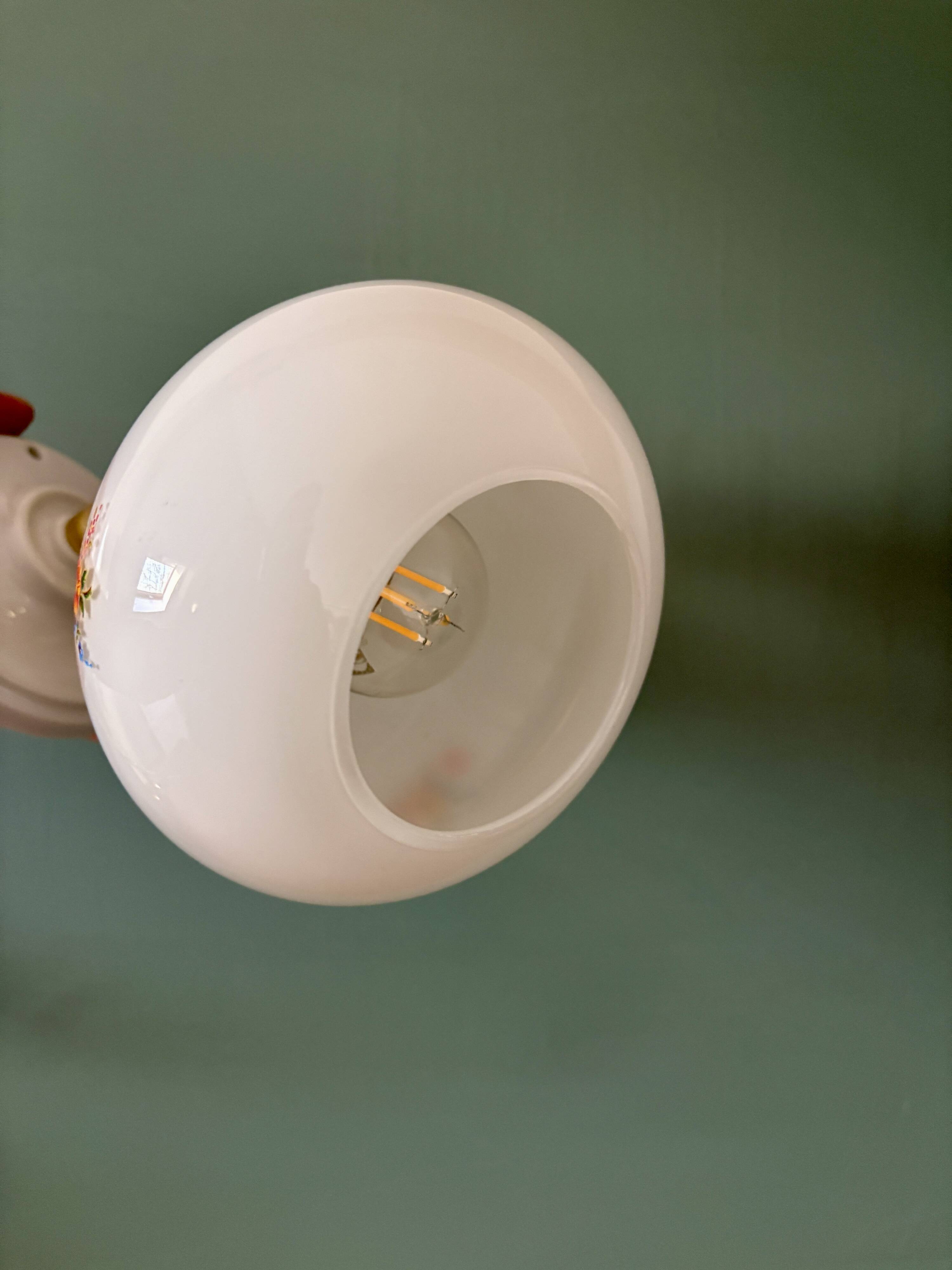 Vintage globe wall sconce in white opaline glass with floral decorations