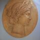 Plaster medallion, high relief, yellow ochre patina, representing the Roman divinity Ceres