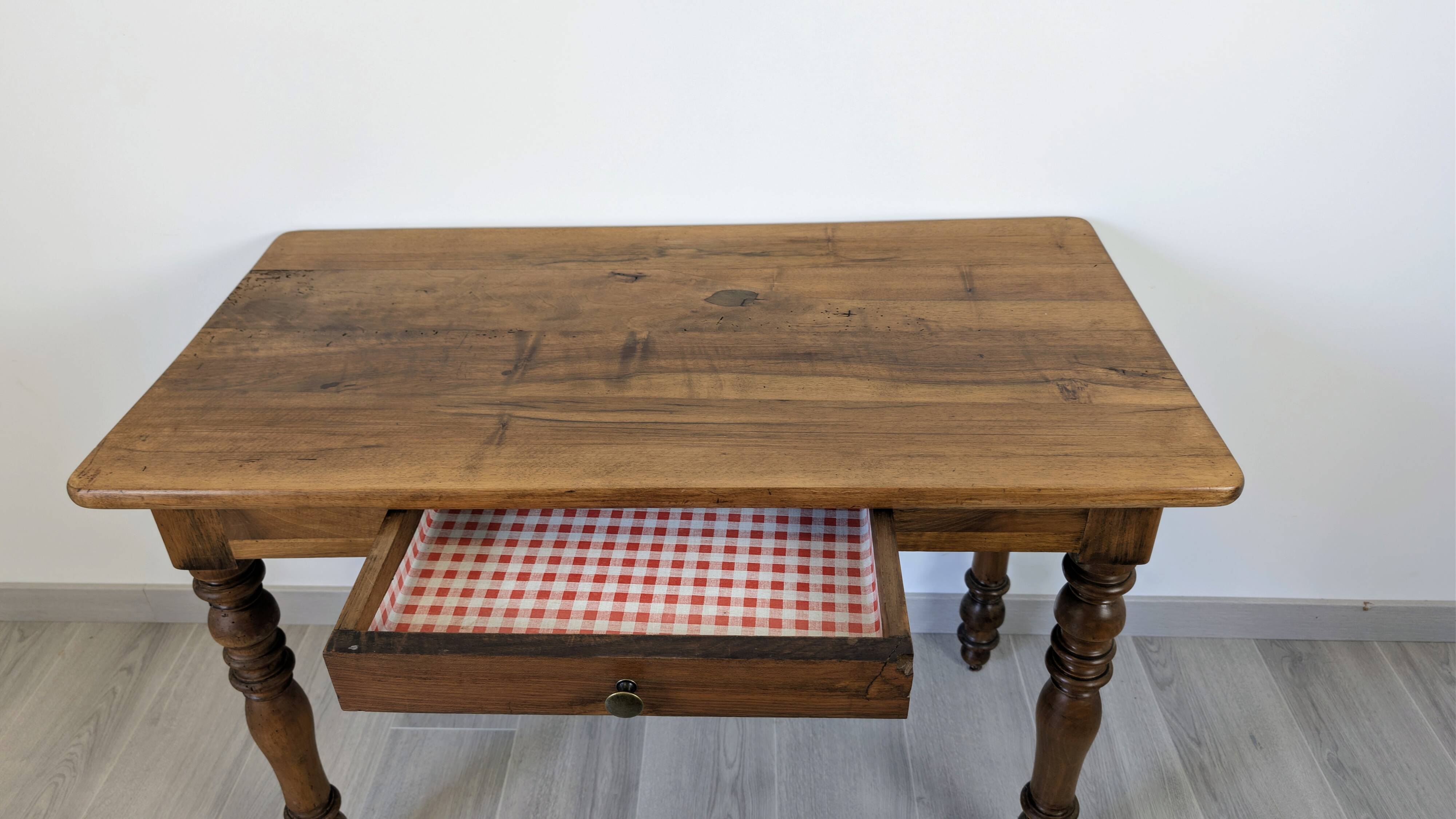 Antique writing table in the Napoleon III style with turned wooden legs.