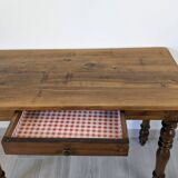 Antique writing table in the Napoleon III style with turned wooden legs.