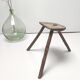 Brutalist tripod stool in solid wood half round