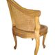 Armchair in solid oak with caning and a central leg (known as couillard), 89x68cm.