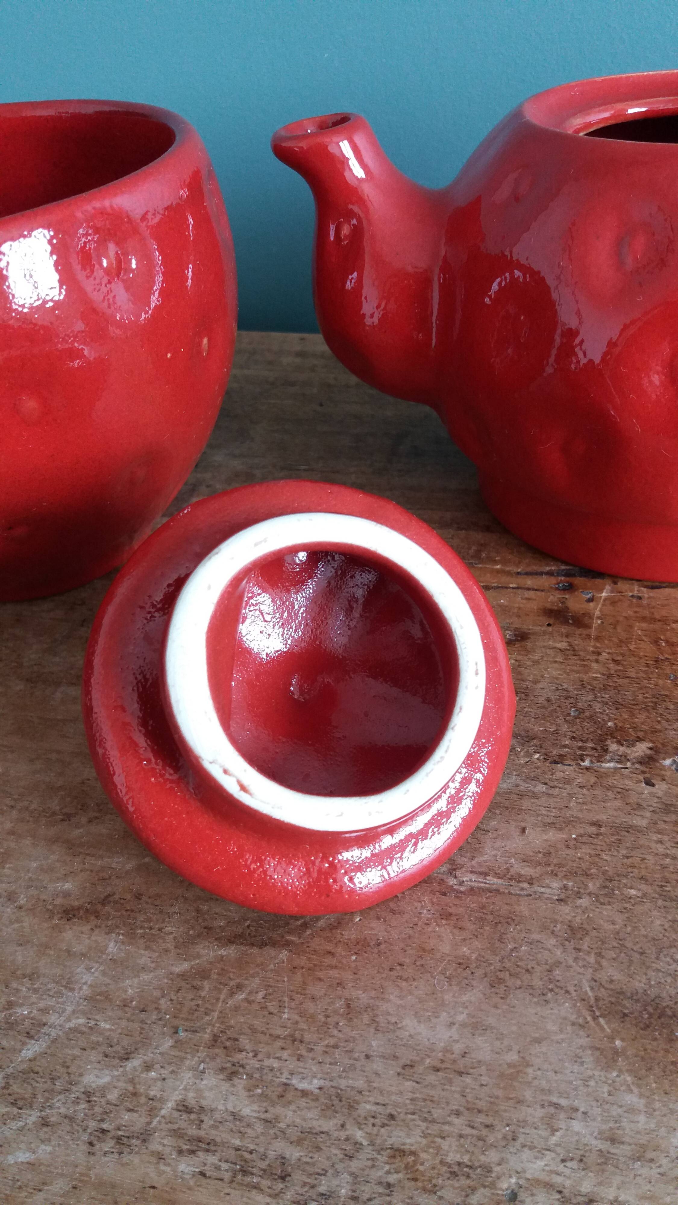 Teapot and cup in the shape of a strawberry.