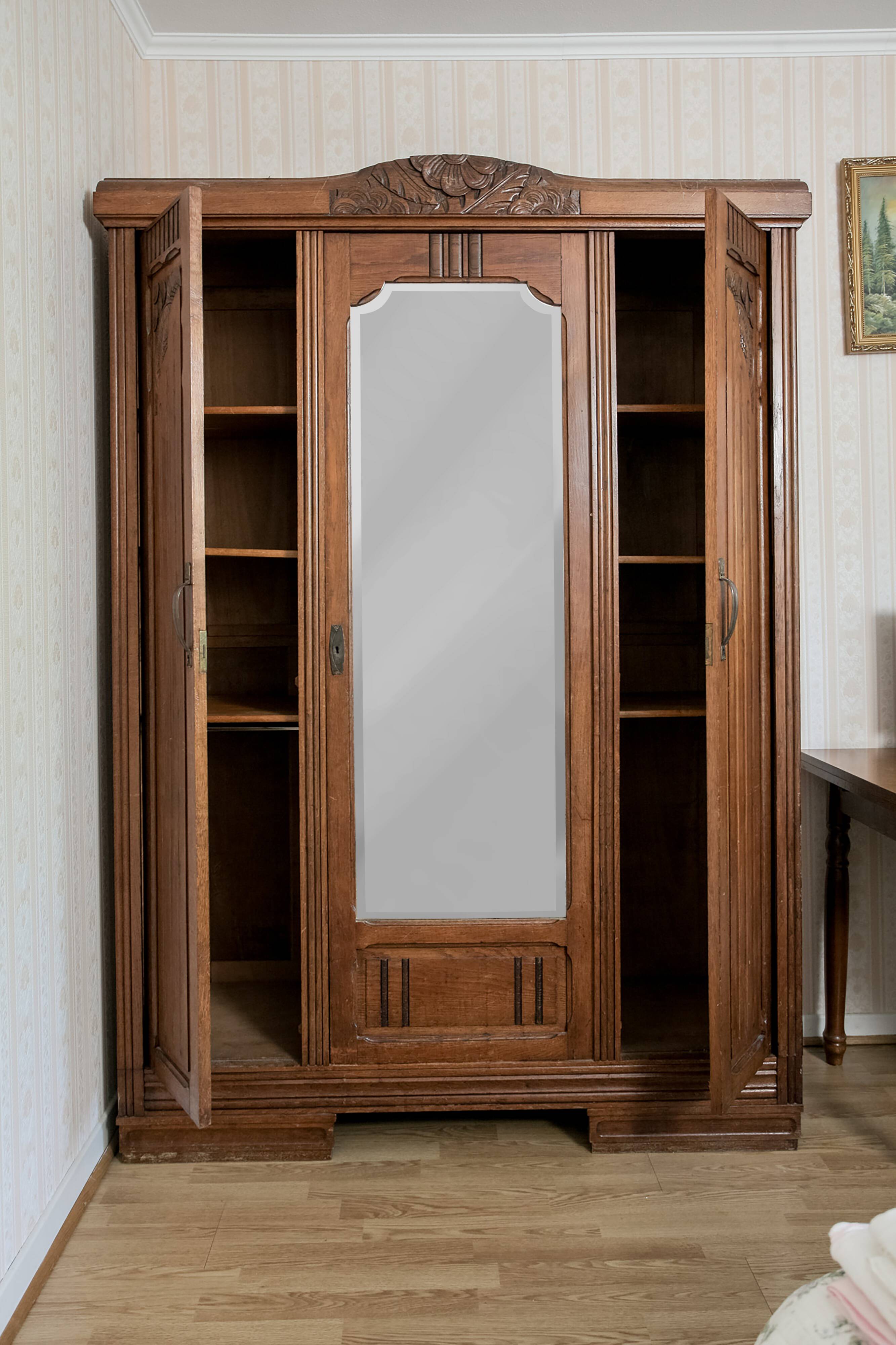 Old solid wood wardrobe with three vintage mirror doors