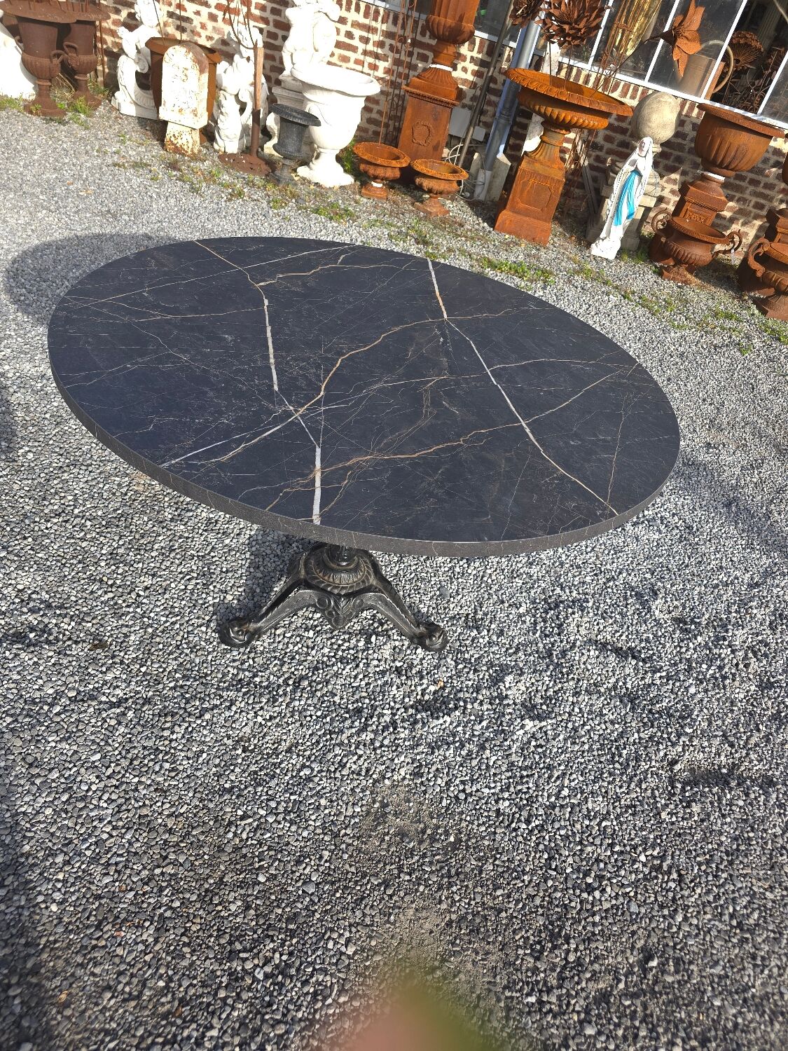 Bistro pedestal table with cast iron base and marble effect top