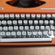 Olympia traveller luxury typewriter orange revised and new ribbon