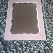 Mid-20th century rectangular wall mirror with a powder pink frame.