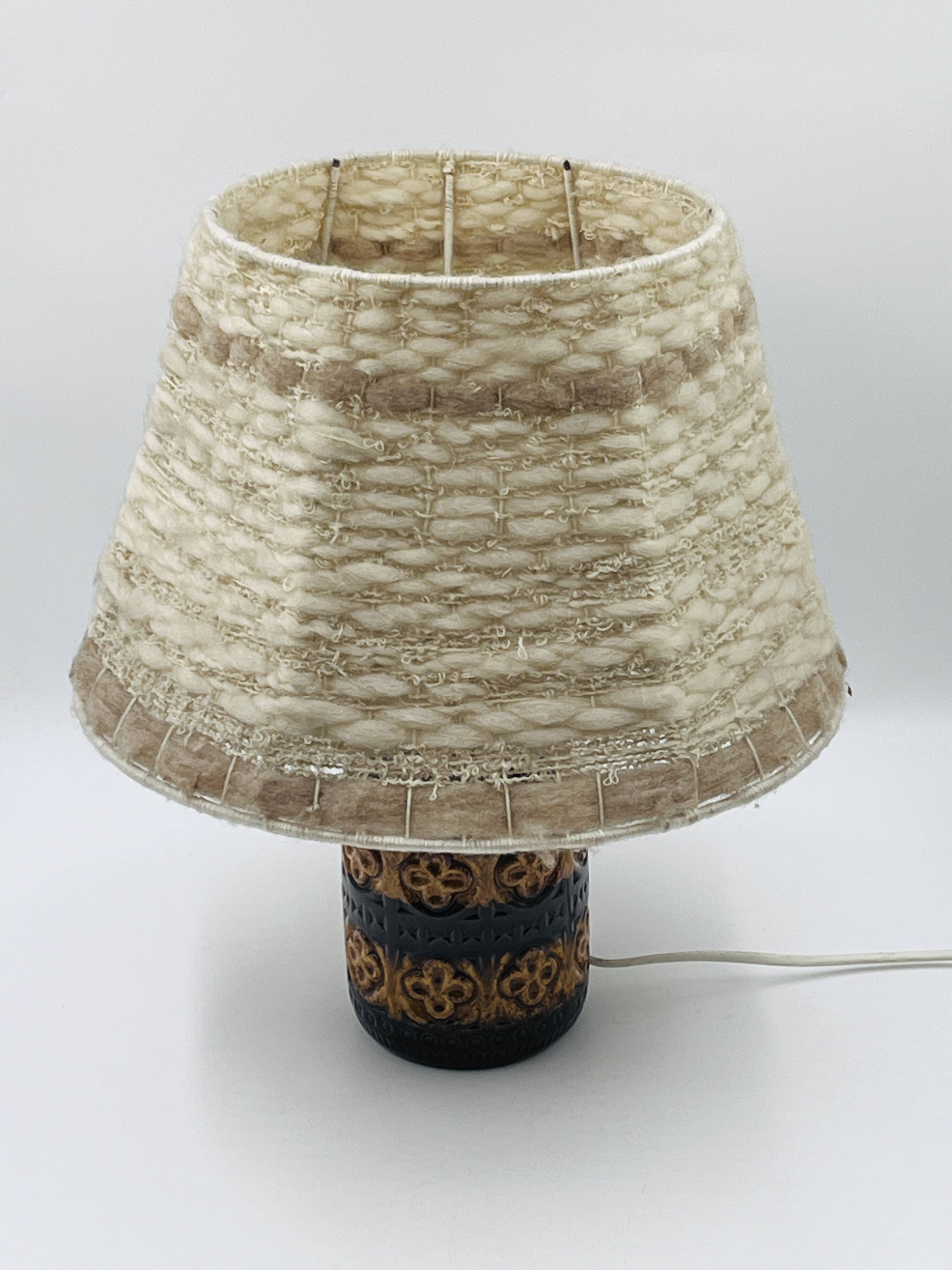 Vintage ceramic lamp with relief and wool shade.