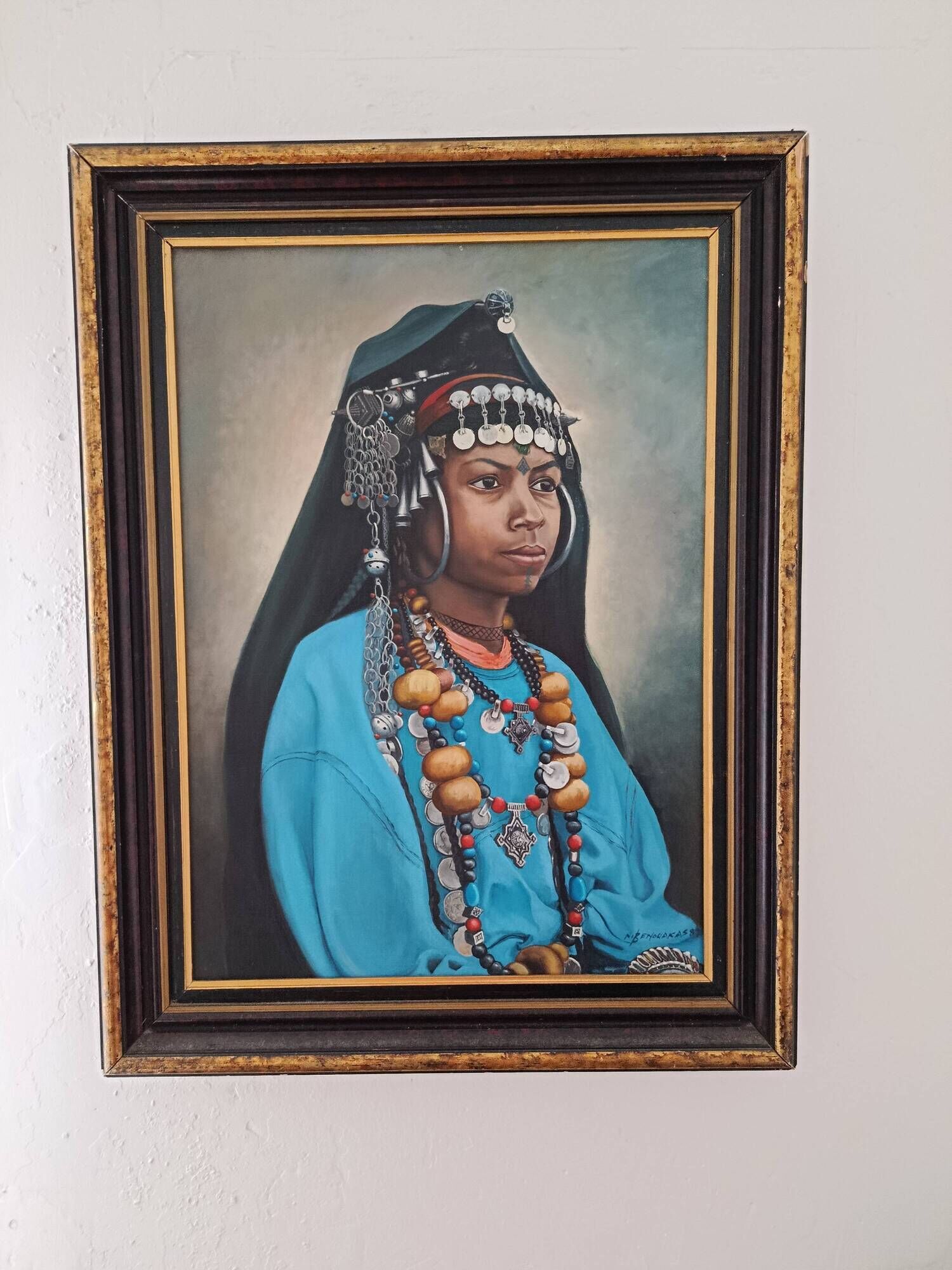 Portrait of a young Moroccan woman in traditional attire and adornments.