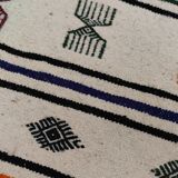 White carpet with multicolored Berber patterns woven hands