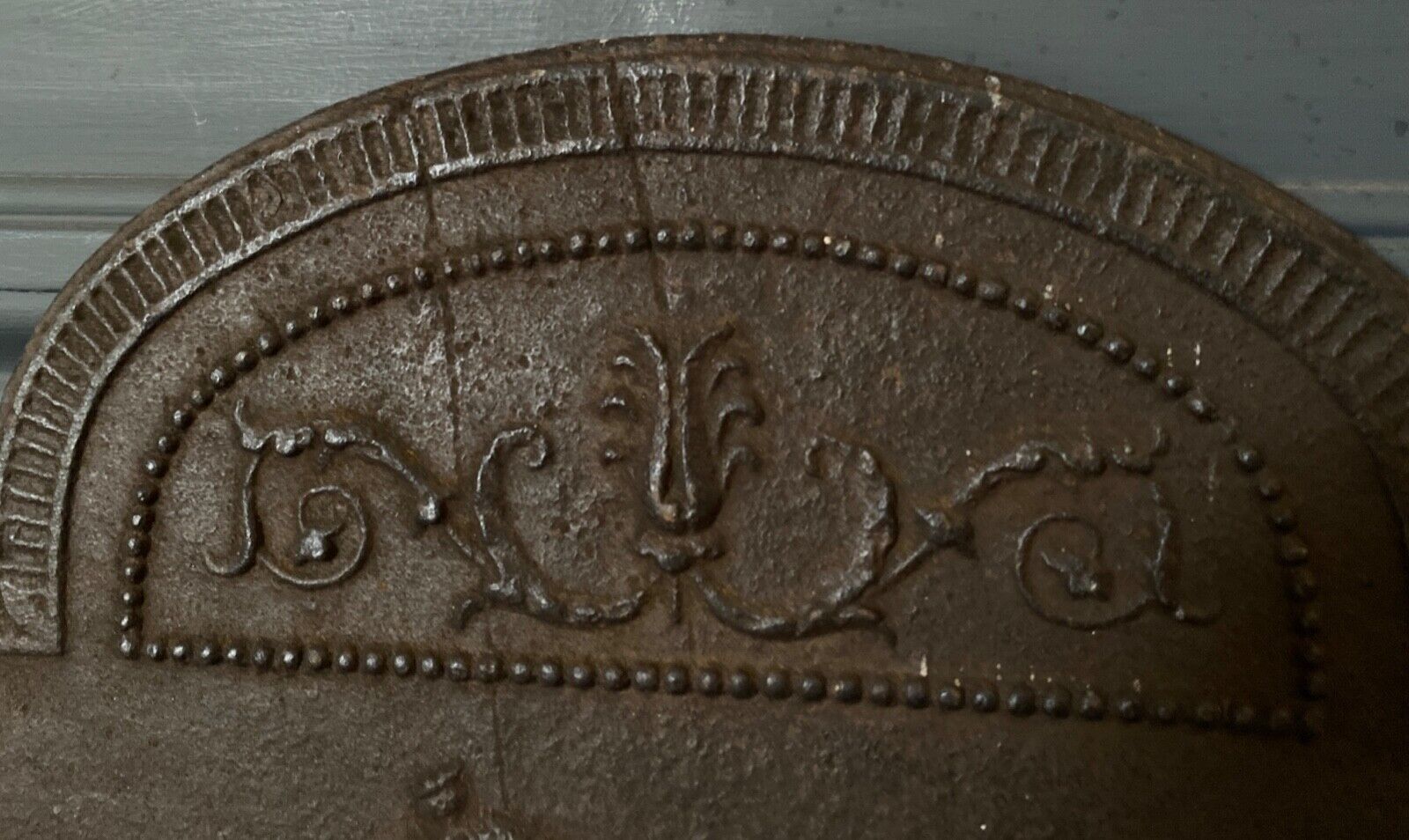 EIGHTEENTH CENTURY CAST IRON FIREPLACE PLATE REPRESENTING A WOMAN AND A WOLF