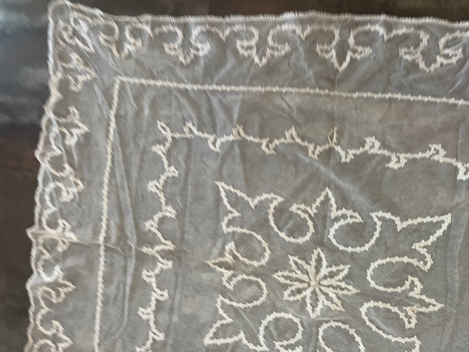 Old tablecloth embroidered with openwork embroidery.