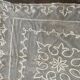 Old tablecloth embroidered with openwork embroidery.