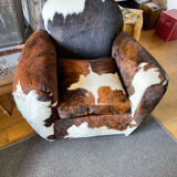 Pair of club chairs covered in cowhide