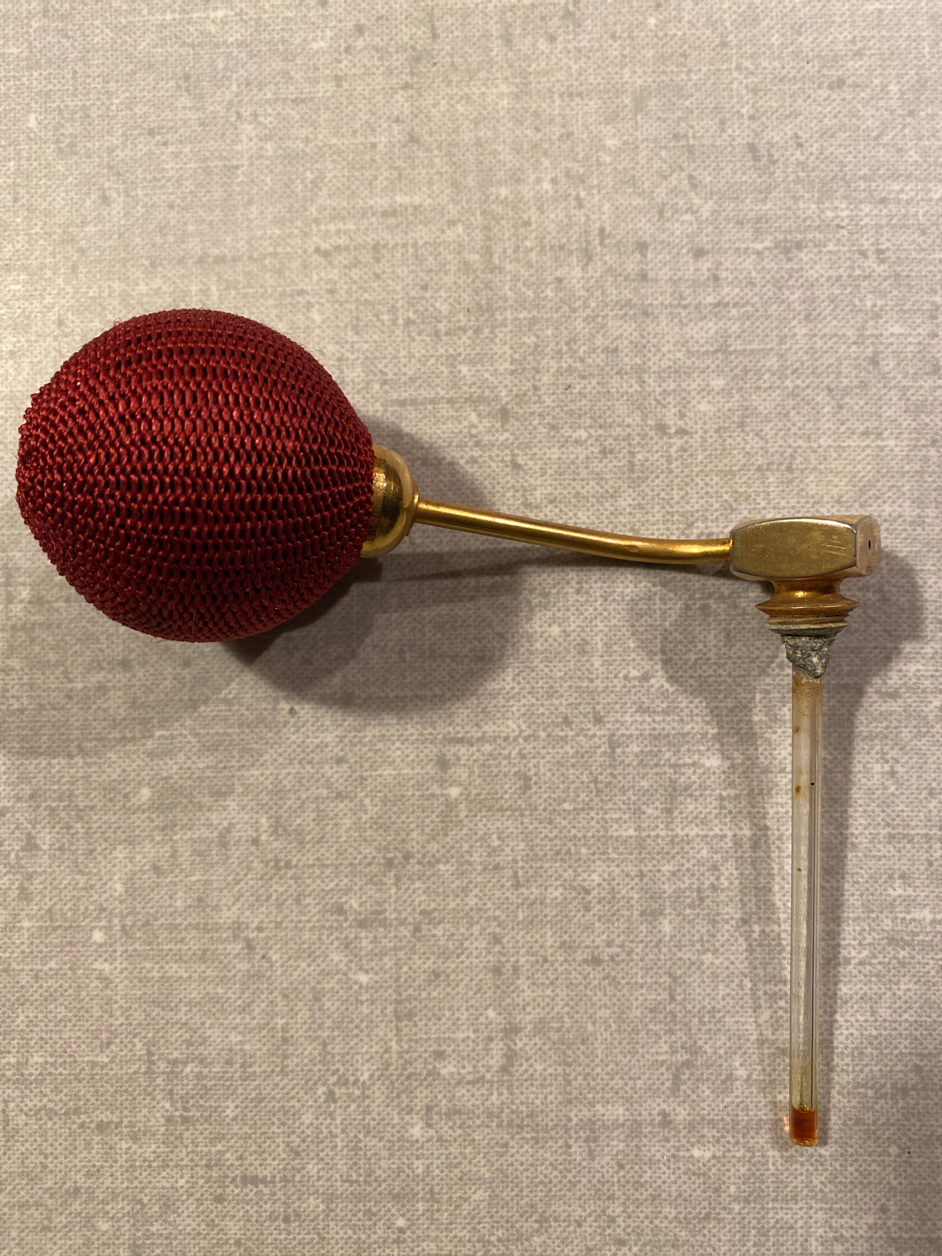 Red crystal perfume spray and red pump.