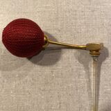 Red crystal perfume spray and red pump.