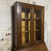 Oak display secretary cabinet with drop-down front, two sections.
