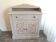 Storage unit with 2 doors and 1 drawer in grey floral design.