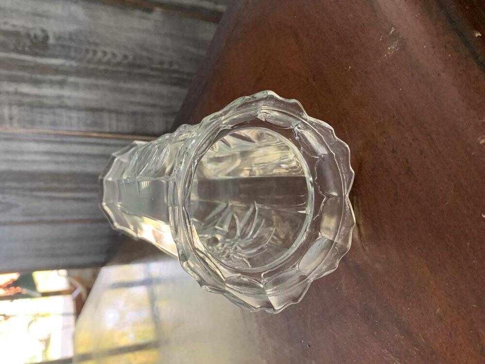 Transparent glass vase with relief floral decoration from the 1980s, fluted neck and polygonal base.