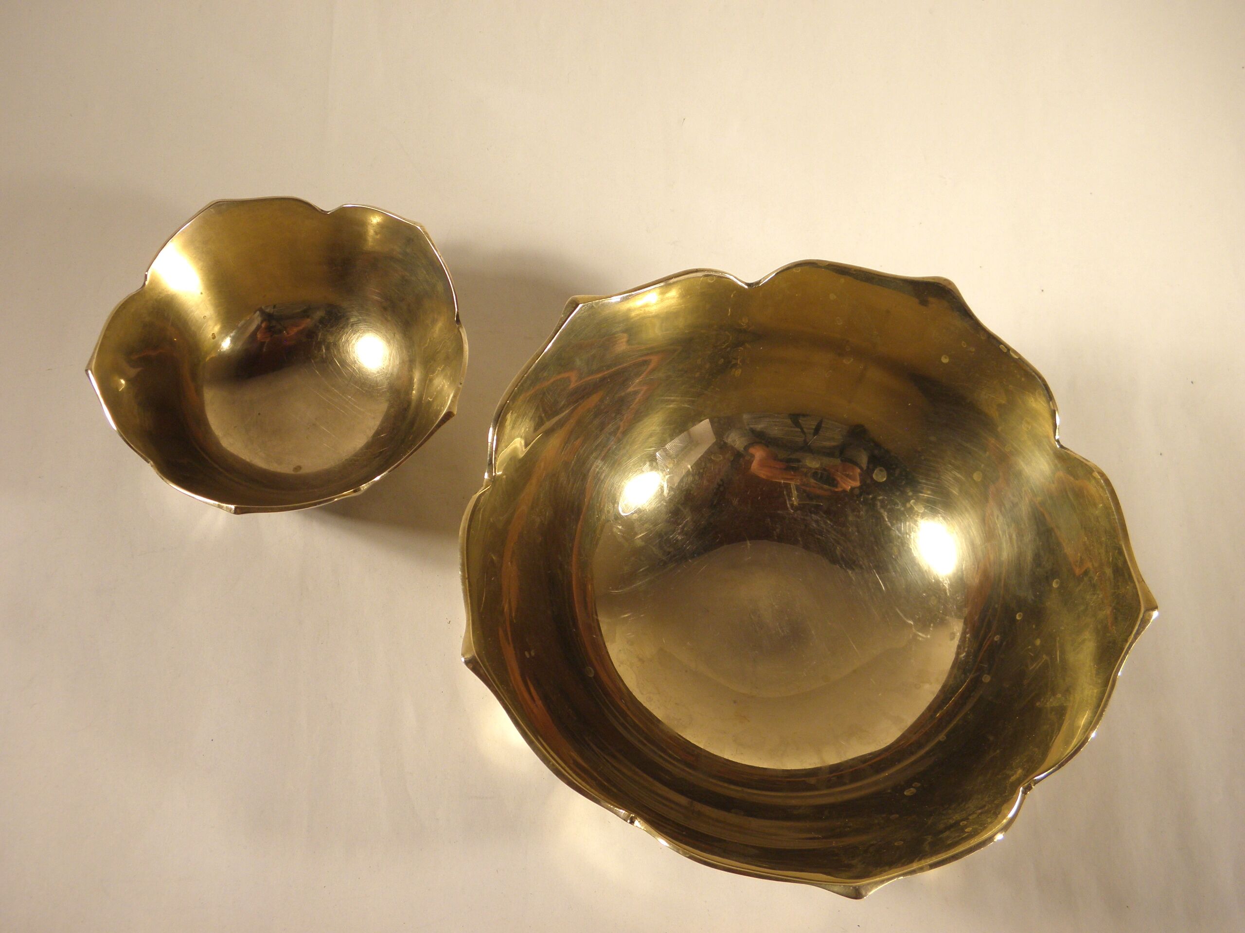 Two brass trundle cups