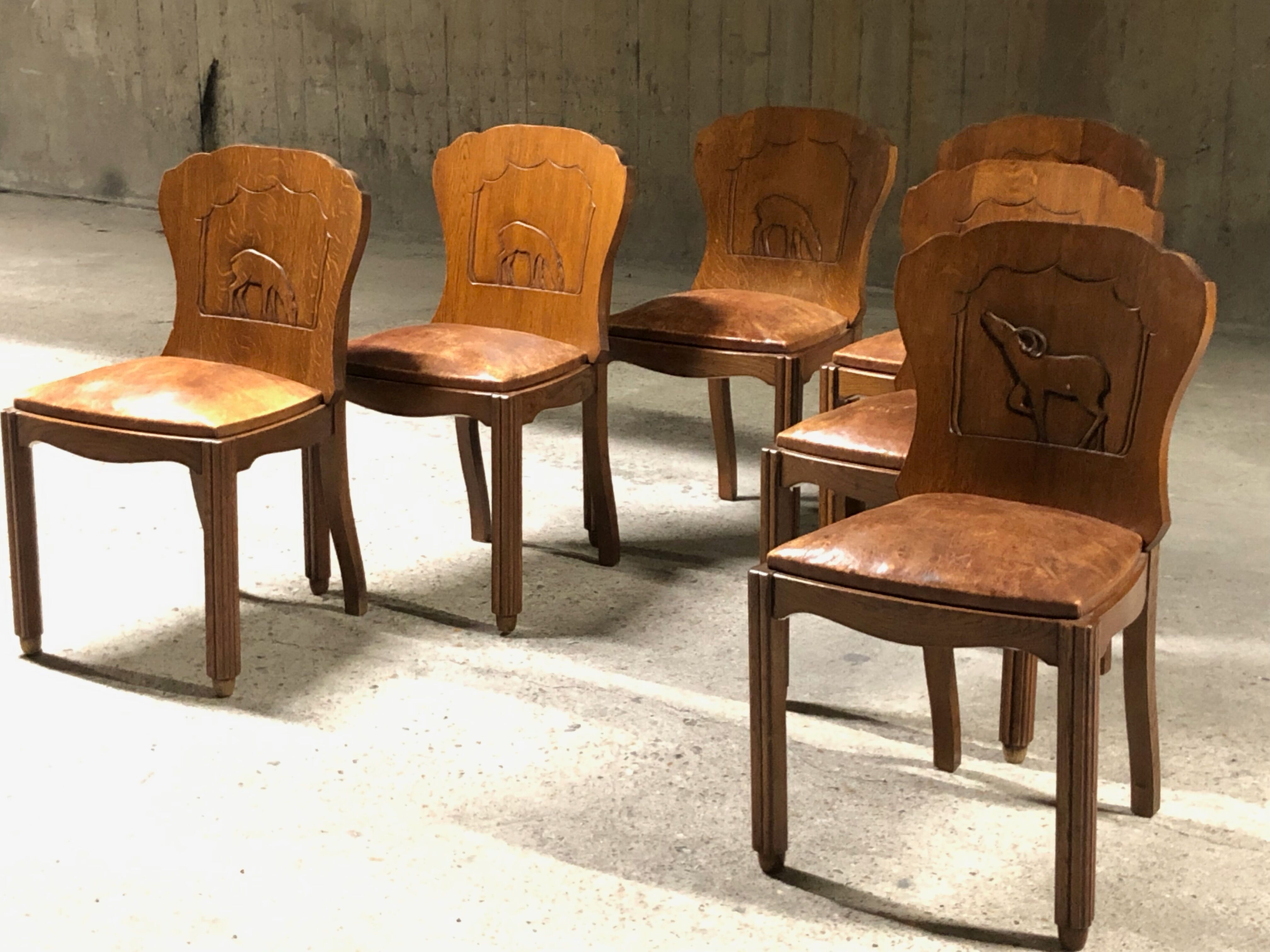 Set of 6 vintage solid wood chairs with animal motif on the back and leather seat