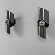 Pair of vintage wall lights, curved patinated steel, France, 1970.