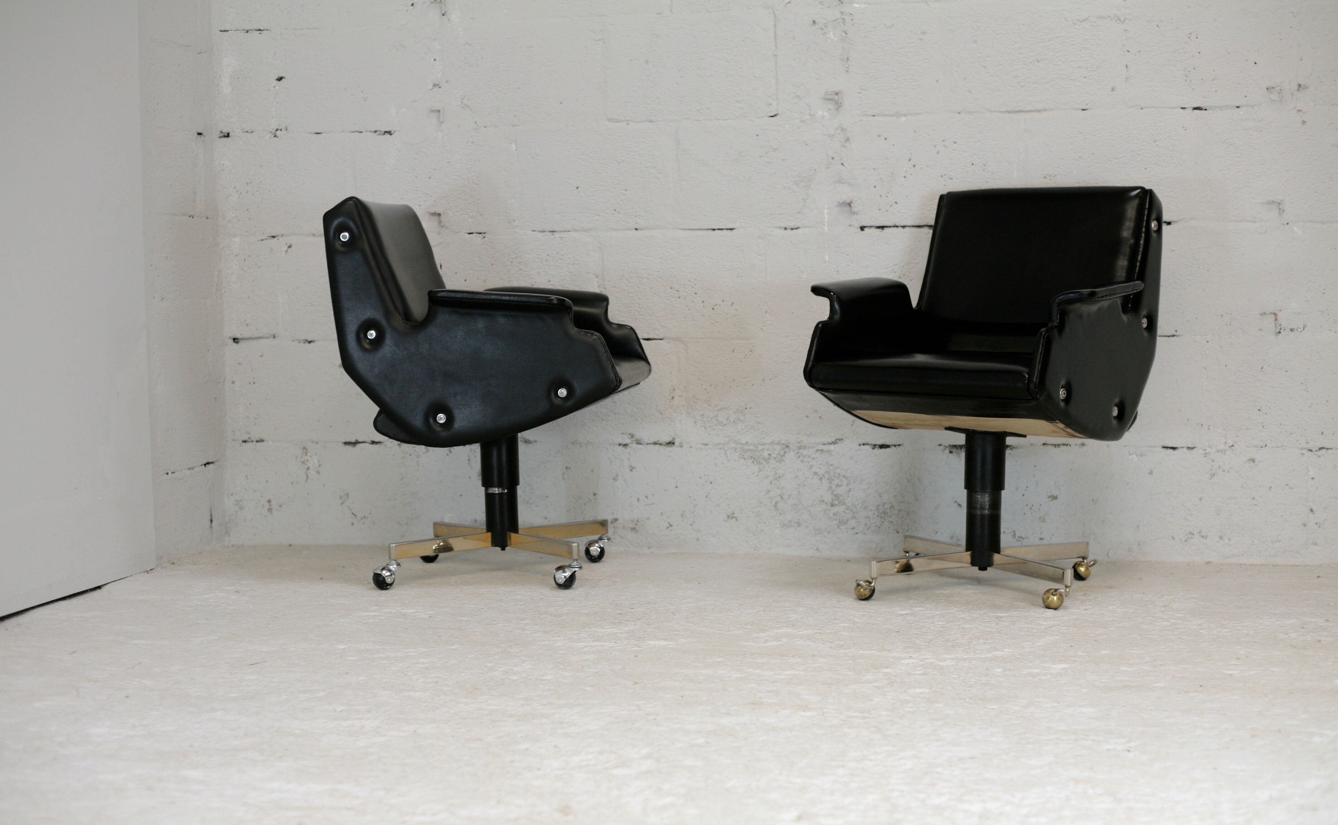 Pair of swivel armchairs, imitation leather and steel, Italy, circa 1960.
