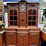 Antique rococo sideboard with integrated clock.