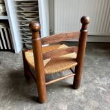 Brutalist low chair in dark wood and straw no. 1