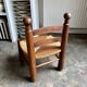 Low brutalist chair in dark wood and straw n°1