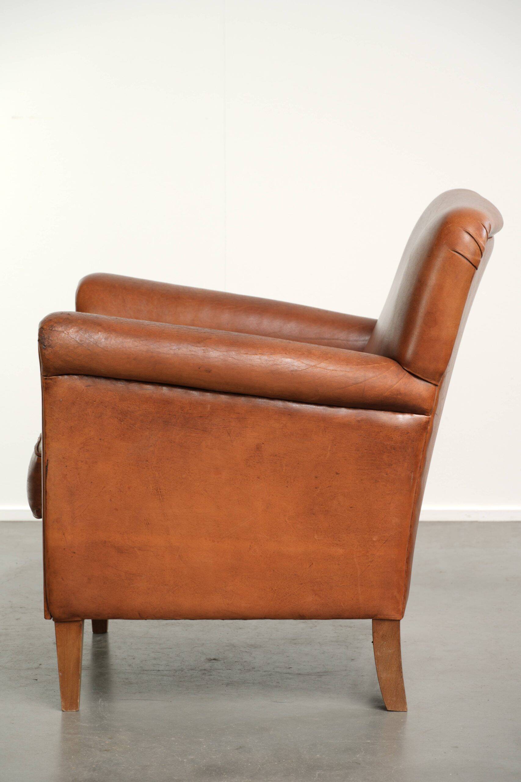 Sturdy vintage sheepskin armchair with a beautiful cognac colour