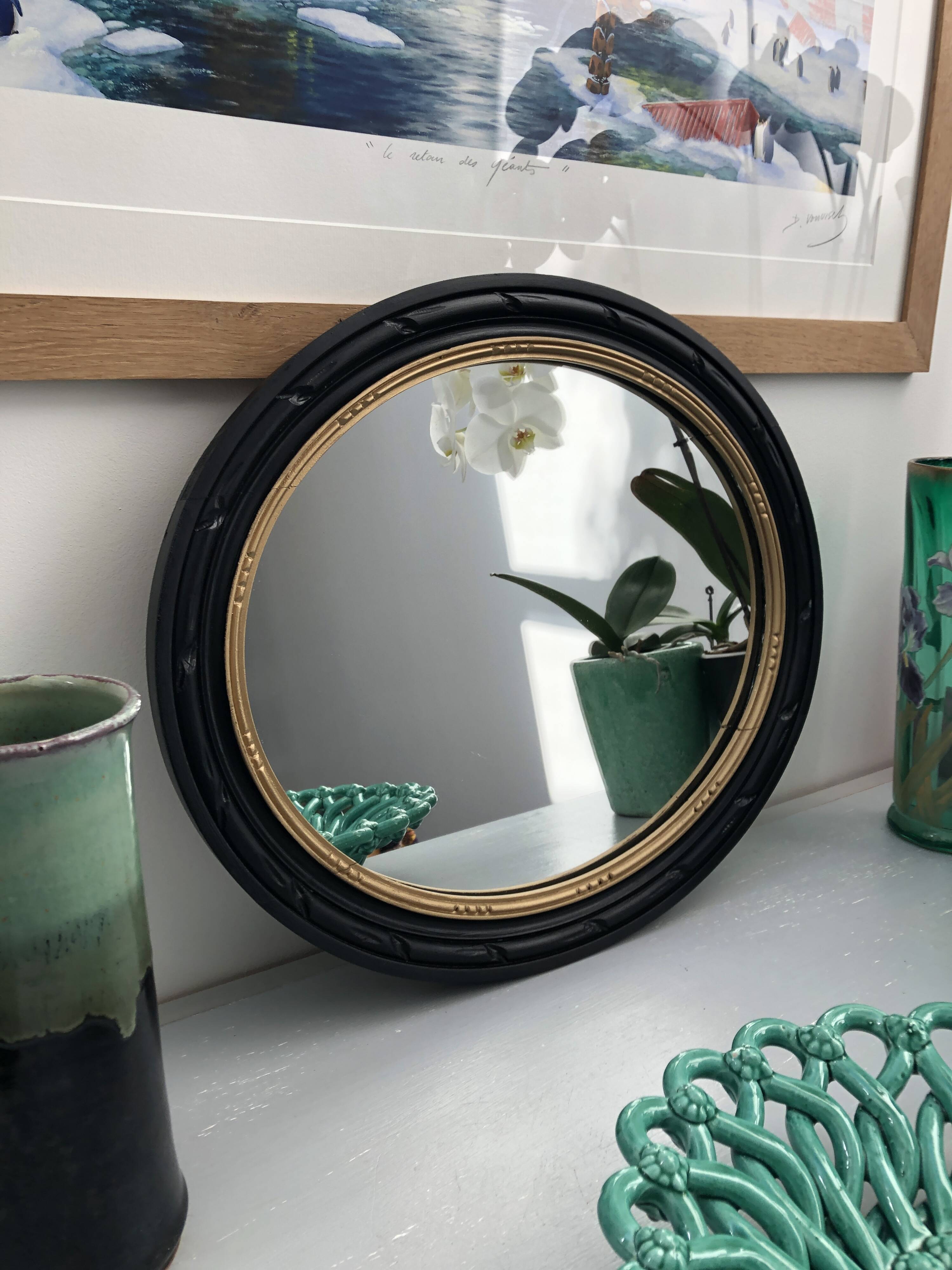 black and gold oval mirror