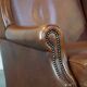 Fauteuil à oreilles en cuir de vachette cognac